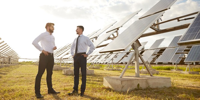 Businessmen talking on solar power plant